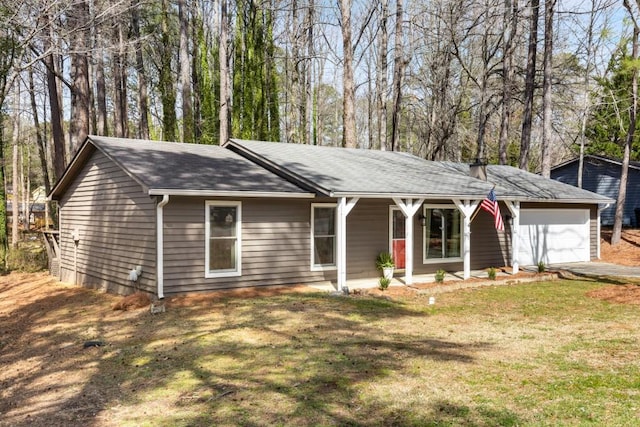 ranch-style home with a front yard, an attached garage, and driveway