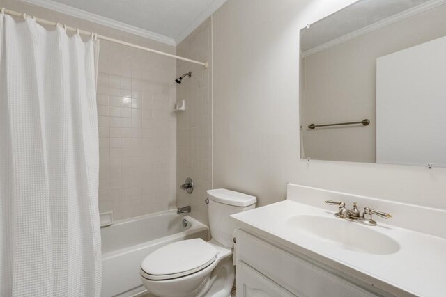 bathroom featuring shower / bath combo with shower curtain, toilet, ornamental molding, and vanity