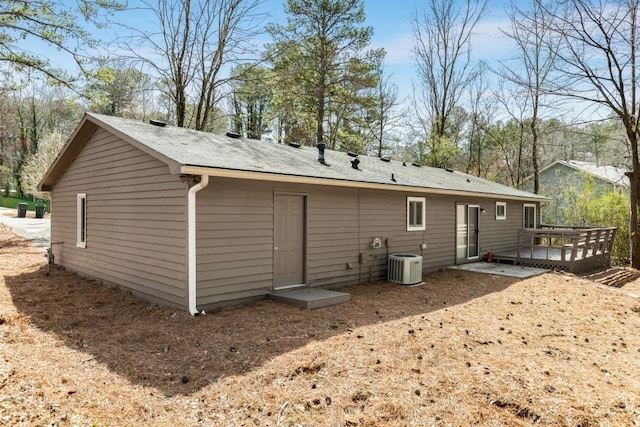 back of house with cooling unit and a deck