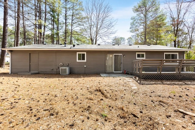 back of property featuring cooling unit and a wooden deck