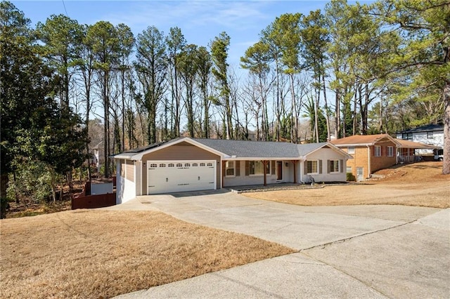 ranch-style house with a garage, concrete driveway, and a front lawn