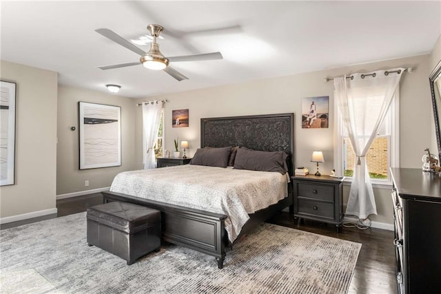 bedroom featuring ceiling fan, dark wood-style flooring, and baseboards