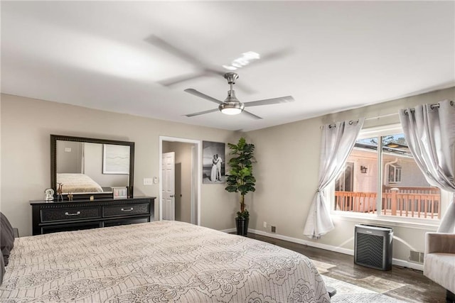 bedroom with a ceiling fan, baseboards, and wood finished floors