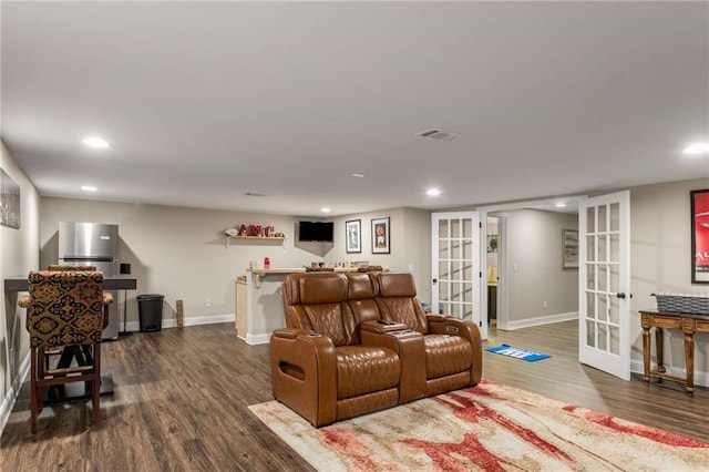 living area featuring french doors, dark wood-style flooring, visible vents, and baseboards