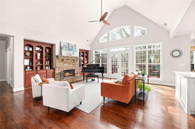 living room featuring high vaulted ceiling, dark hardwood / wood-style floors, a fireplace, and french doors