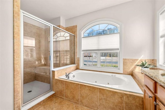 bathroom featuring vanity, independent shower and bath, and tile patterned flooring