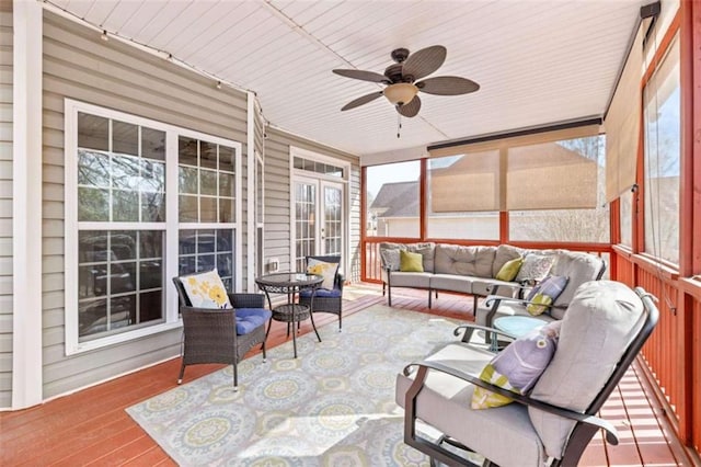 sunroom / solarium featuring ceiling fan and a healthy amount of sunlight