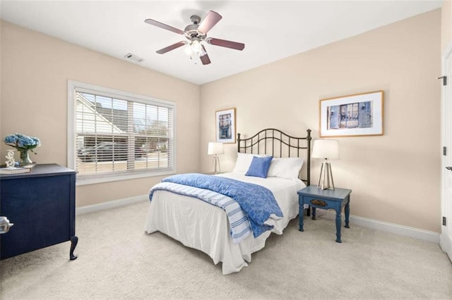 bedroom with ceiling fan and light carpet