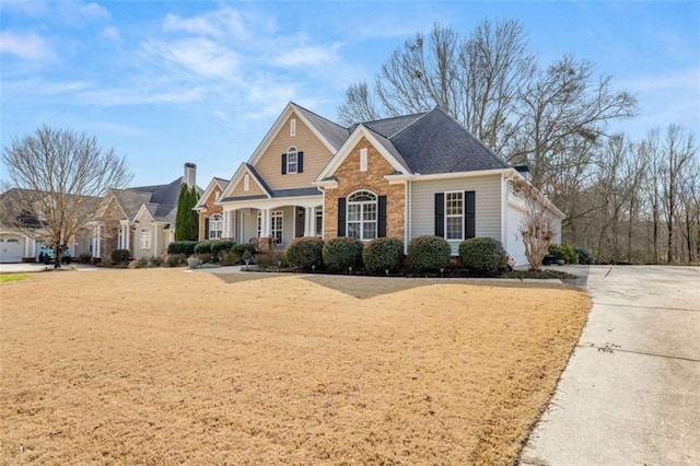 view of front of home with a garage and a front lawn