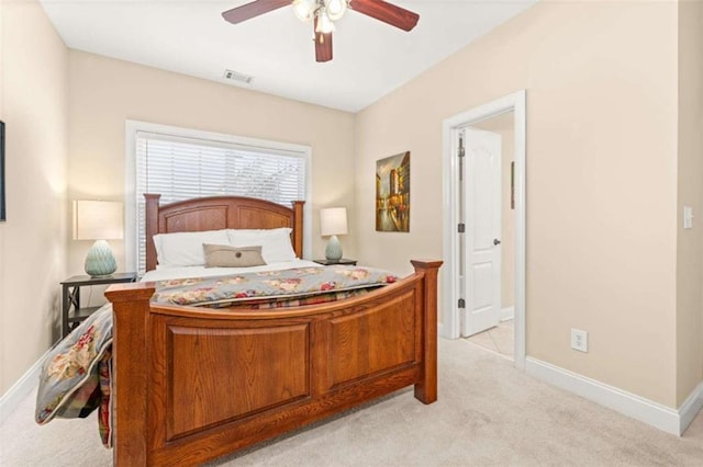 carpeted bedroom featuring ensuite bath and ceiling fan