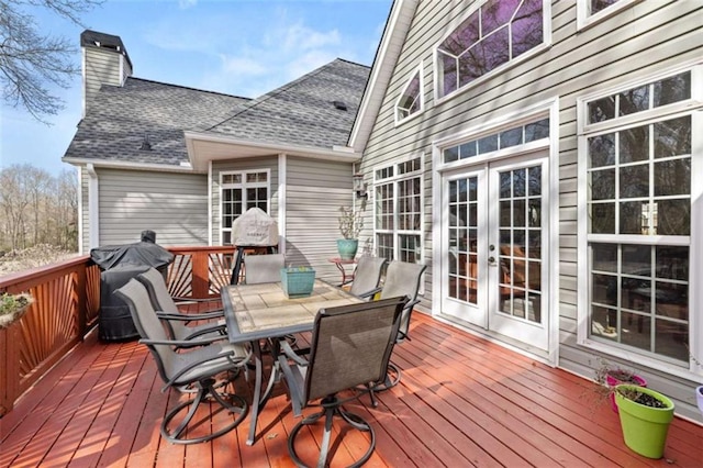 wooden terrace with area for grilling and french doors