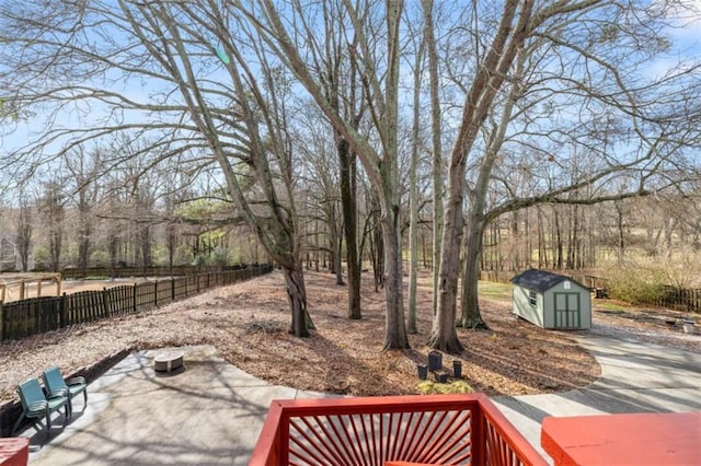 view of yard with a storage shed and a patio