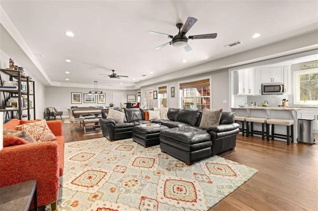 living room with ceiling fan and light hardwood / wood-style floors