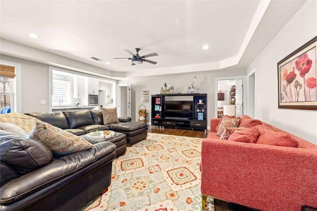 living room with hardwood / wood-style floors and ceiling fan