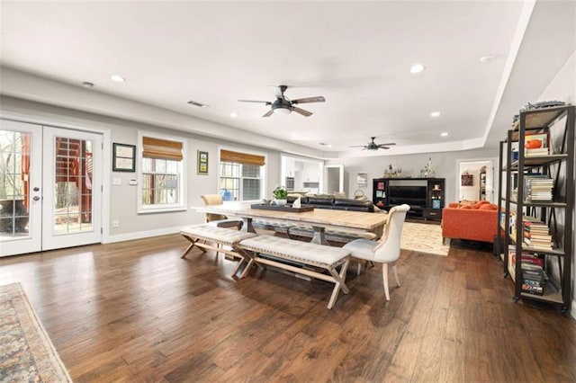 dining space featuring dark hardwood / wood-style floors, ceiling fan, and french doors