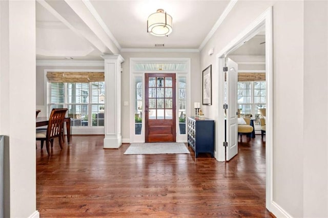 entrance foyer with crown molding, dark wood-type flooring, and ornate columns