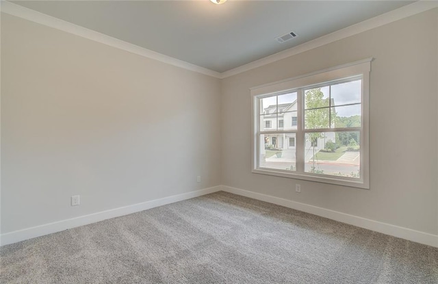 carpeted empty room featuring baseboards, visible vents, and ornamental molding