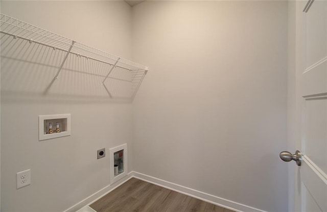 clothes washing area featuring washer hookup, dark wood finished floors, electric dryer hookup, laundry area, and baseboards