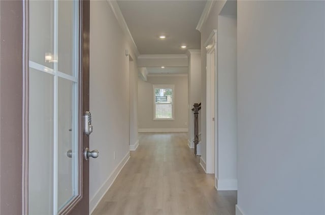 corridor featuring baseboards, recessed lighting, light wood-type flooring, and crown molding