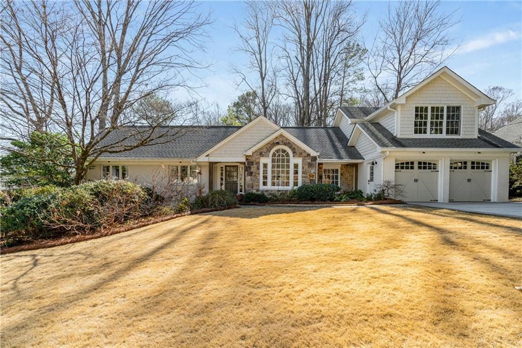 view of front of house featuring a garage and a front lawn