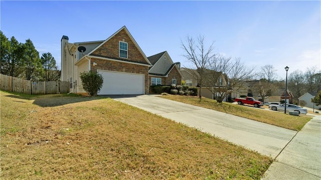 view of side of home featuring a yard, a chimney, fence, a garage, and driveway