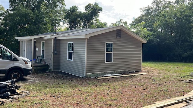 view of property exterior with a lawn