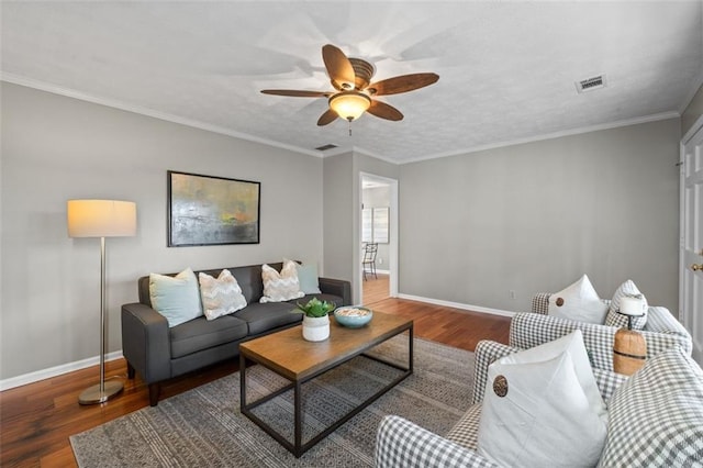 living room with ceiling fan, baseboards, wood finished floors, and ornamental molding