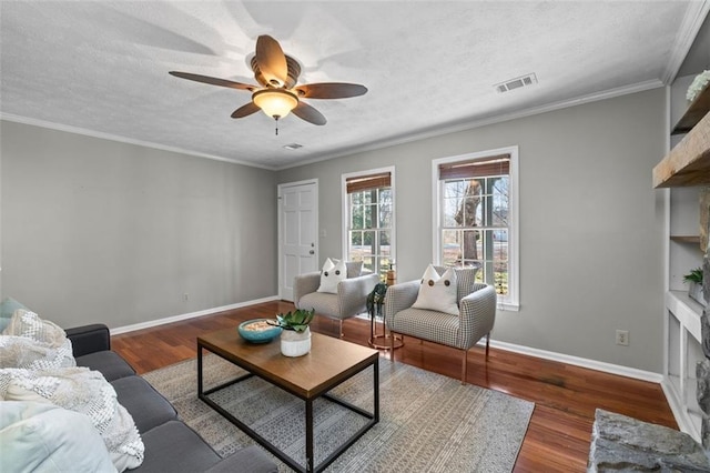 living room featuring a textured ceiling, visible vents, and wood finished floors