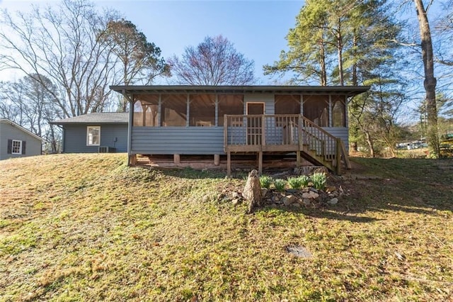 view of front of property featuring a sunroom and stairway