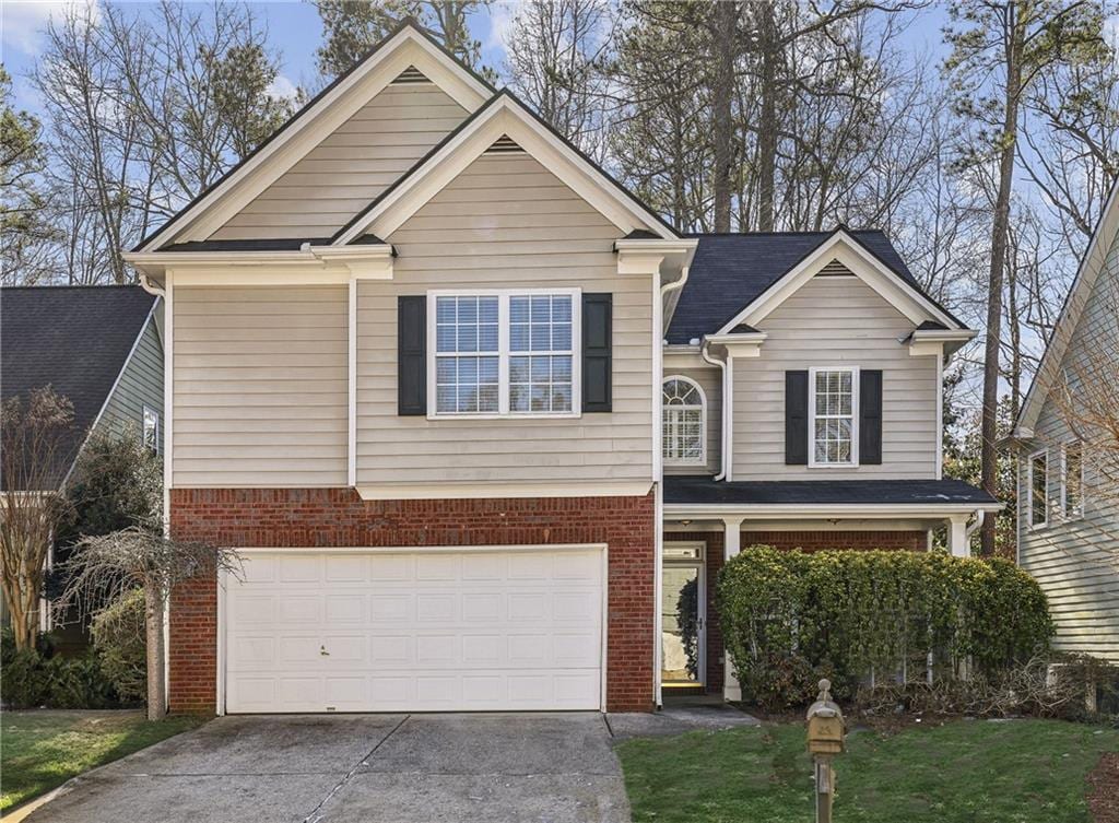 view of front facade with a front yard and a garage