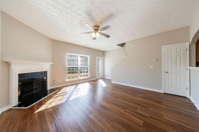 2873 Snapfinger Mnr, Decatur, GA 30035 - unfurnished living room with wood finished floors, ceiling fan, a premium fireplace, and a textured ceiling