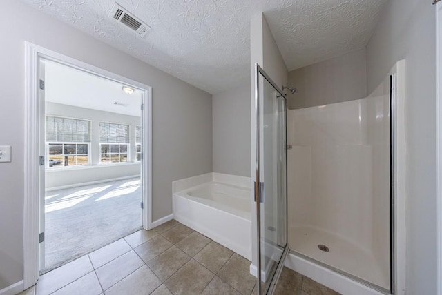 2873 Snapfinger Mnr, Decatur, GA 30035 - full bath with a bath, a shower stall, tile patterned floors, and a textured ceiling