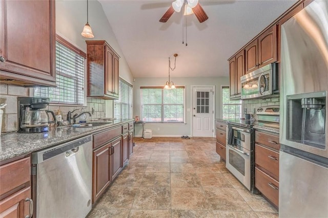 200 Wildwood Cir SE, Calhoun, GA 30701 - kitchen featuring appliances with stainless steel finishes, lofted ceiling, a sink, backsplash, and a ceiling fan