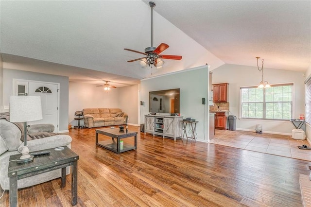 200 Wildwood Cir SE, Calhoun, GA 30701 - living area with a ceiling fan, lofted ceiling, light wood-type flooring, and baseboards