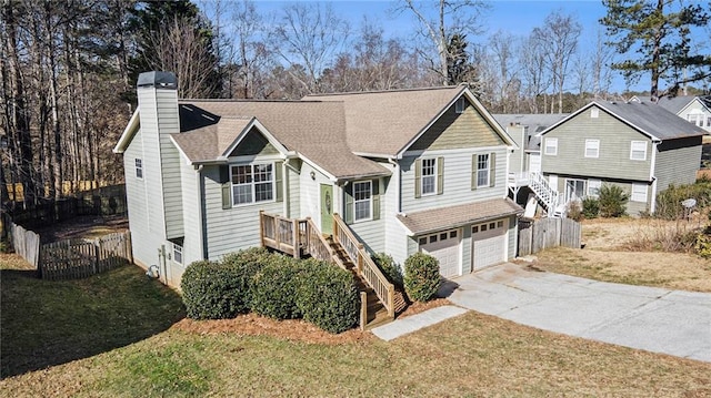 view of front of property with a garage and a front lawn