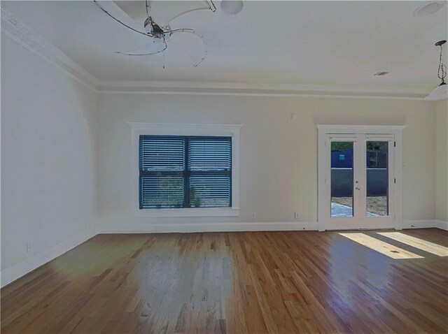 half bath with wood finished floors, toilet, and baseboards