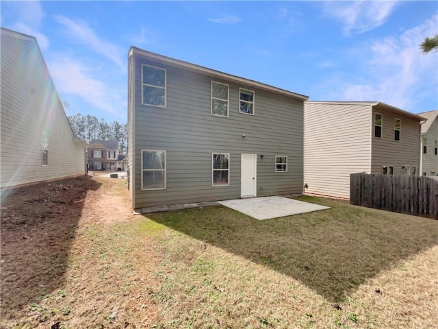 rear view of house with a patio area, fence, and a lawn