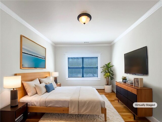 bedroom featuring a tray ceiling, multiple windows, ensuite bath, and baseboards