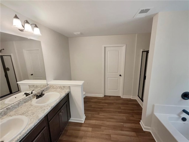 full bath with a shower stall, visible vents, and a sink