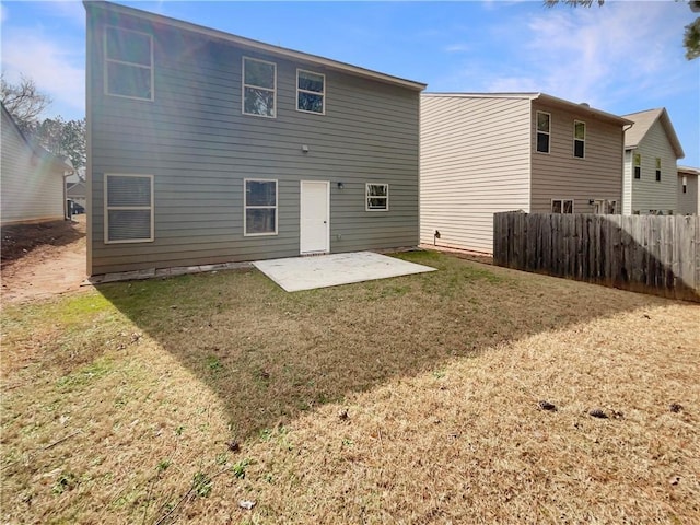 rear view of property with a patio, a yard, and fence