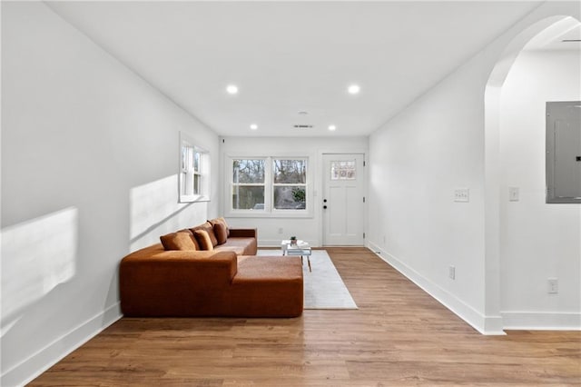 living room featuring light hardwood / wood-style floors and electric panel