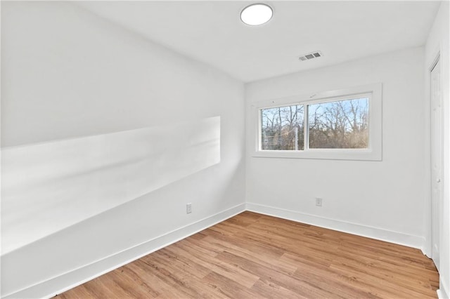 spare room featuring light hardwood / wood-style floors