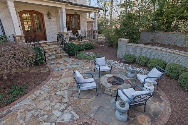 view of patio / terrace featuring an outdoor fire pit and french doors