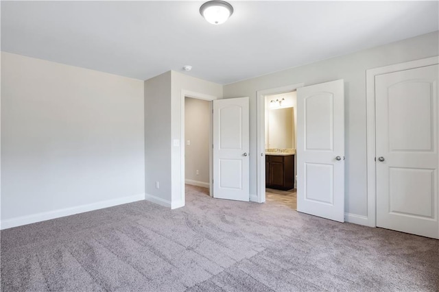 237 Lotus Ln, Covington, GA 30016 - unfurnished bedroom with light carpet and ensuite bath