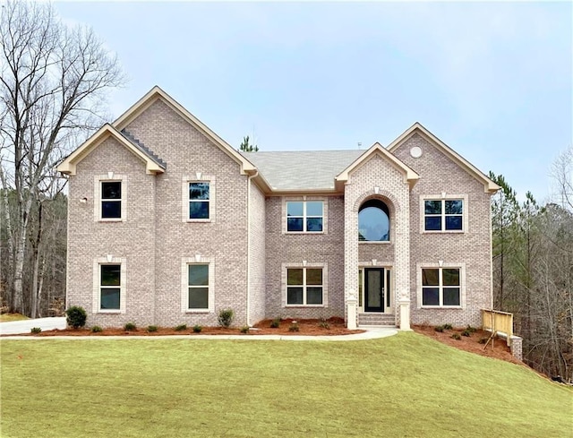 237 Lotus Ln, Covington, GA 30016 - traditional-style house with a front yard and brick siding