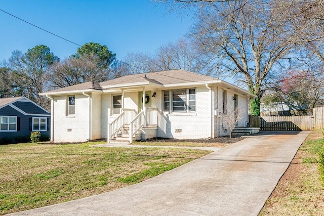 bungalow-style house with a front lawn, crawl space, fence, and brick siding