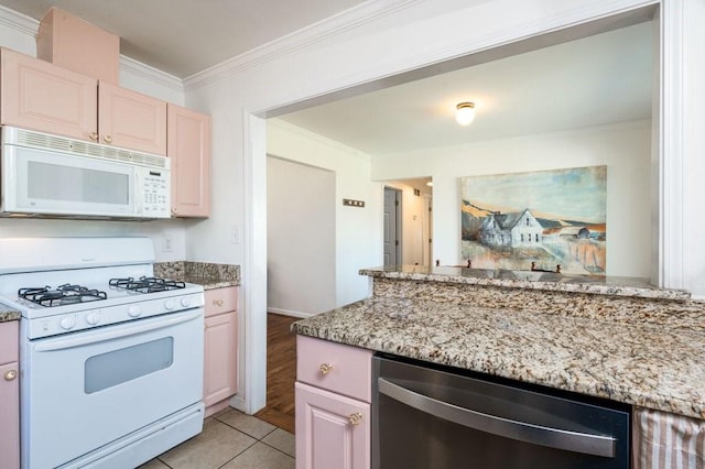 kitchen featuring light tile patterned floors, white appliances, light stone countertops, and crown molding