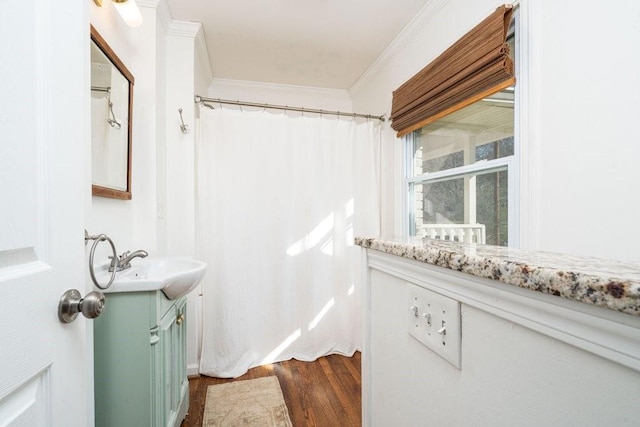 bathroom with a shower with shower curtain, wood finished floors, vanity, and crown molding