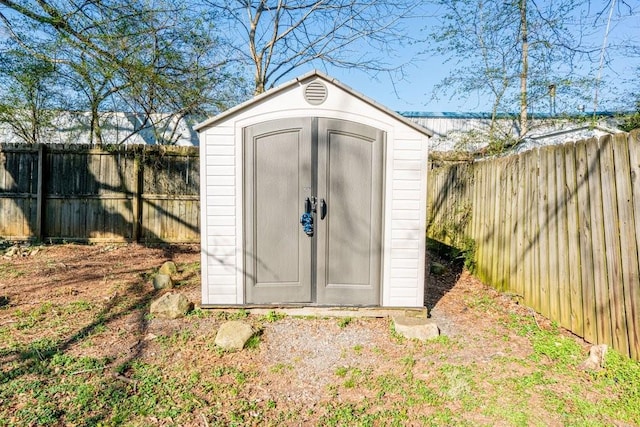 view of shed with a fenced backyard