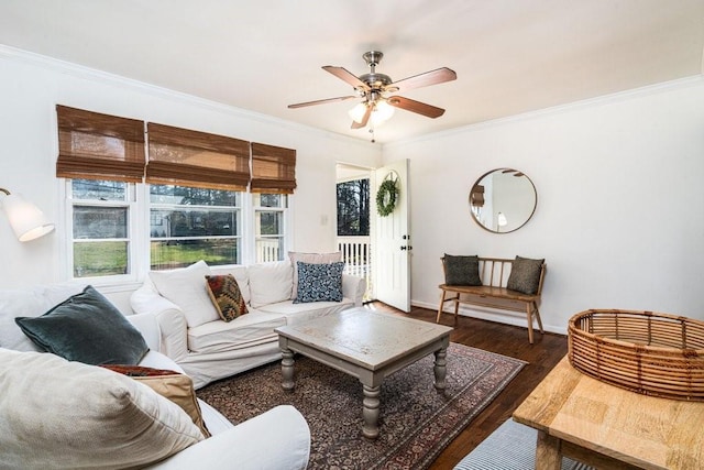 living room featuring baseboards, ceiling fan, wood finished floors, and crown molding